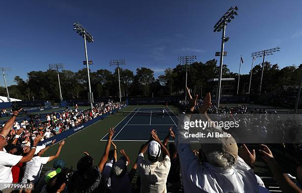 Fans cheer as Viktor Troicki of Serbia reacts after defeating Radu Albot of Moldova during her first round Women's Singles match on Day Two of the...