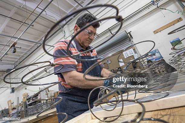 Worker assembles a box spring at the McRoskey Mattress Co. Facility in San Francisco, California, U.S., on Tuesday, Aug. 30, 2016. The Commerce...