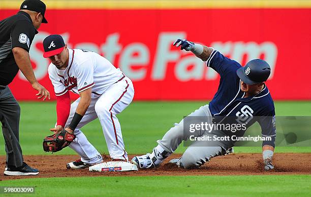 Oswaldo Arcia of the San Diego Padres slides in to second base for a double against Jace Peterson of the Atlanta Braves during the second inning at...