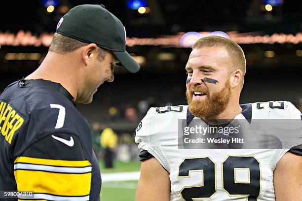 John Kuhn of the New Orleans Saints talks after a preseason game with Ben Roethlisberger of the Pittsburgh Steelers at Mercedes-Benz Superdome on...