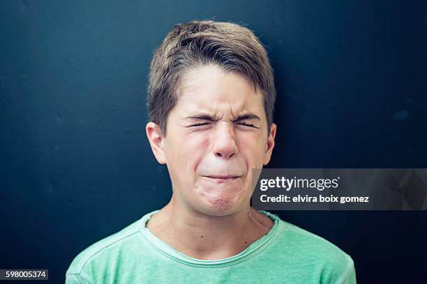 boy grimacing - sour taste stock pictures, royalty-free photos & images