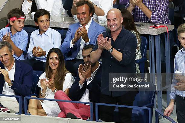 Andre Agassi waves to the crowd during the reveal of the LAVAZZA 'I'm Back' campaign at USTA Billie Jean King National Tennis Center on August 30,...