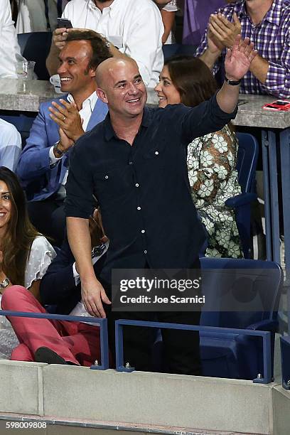 Andre Agassi waves to the crowd during the reveal of the LAVAZZA 'I'm Back' campaign at USTA Billie Jean King National Tennis Center on August 30,...