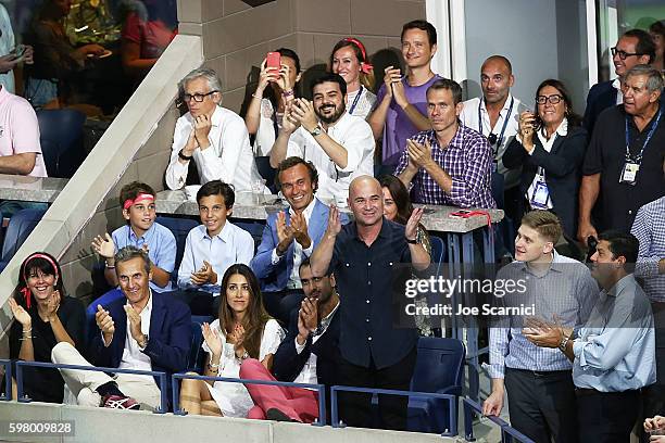 Andre Agassi waves to the crowd during the reveal of the LAVAZZA 'I'm Back' campaign at USTA Billie Jean King National Tennis Center on August 30,...