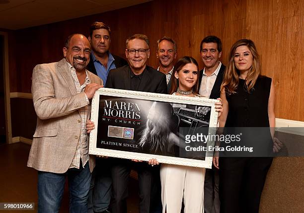 Singer Maren Morris recieves a platinum record for hit song "My Church" backstage at the 10th Annual ACM Honors at the Ryman Auditorium on August 30,...