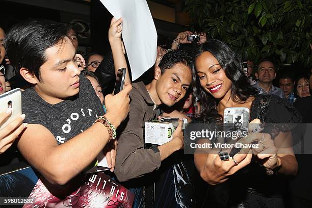 Actress Zoe Saldana signs autographs and takes selfies with fans during the promotional tour of the Paramount Pictures title "Star Trek Beyond" at...