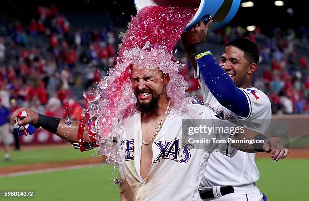 Elvis Andrus of the Texas Rangers soaks Rougned Odor of the Texas Rangers with the Powerade cooler after Odor hit a two-run walk-off homerun against...