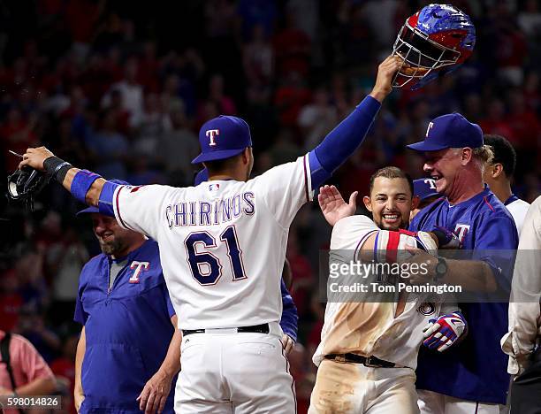 Rougned Odor of the Texas Rangers celebrates with Robinson Chirinos of the Texas Rangers and Steve Buechele of the Texas Rangers after hitting a...