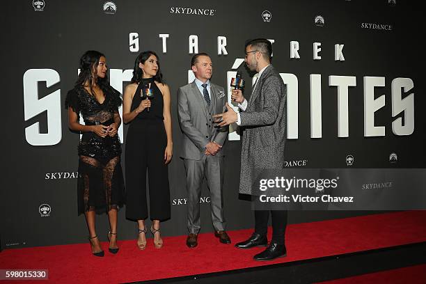 Actress Zoe Saldana and actor Simon Pegg speak with host David Alfaro during the premiere of the Paramount Pictures title "Star Trek Beyond" at...