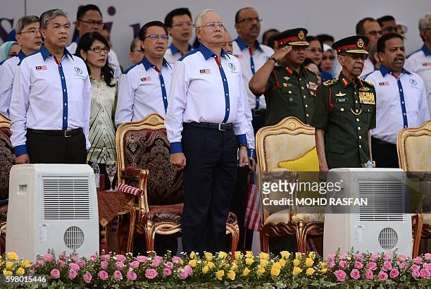 Malaysian Deputy Prime Minister Ahmad Zahid Hamidi, Malaysia's Prime Minister Najib Razak, and Malaysia's King Abdul Halim Mu'adzam Shah observe the...