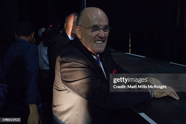 Former New York Mayor Rudy Giuliani stands backstage during campaign rally for Republican presidential candidate Donald Trump on August 30, 2016 in...