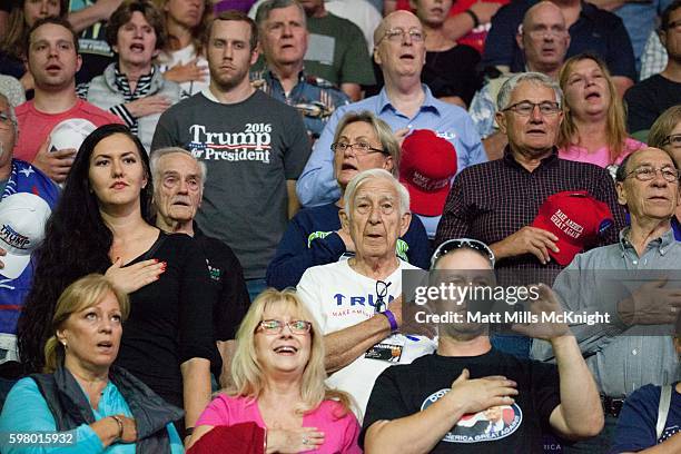 Supporters recite the pledge of allegiance during a campaign rally for Republican presidential candidate Donald Trump on August 30, 2016 at Xfinity...