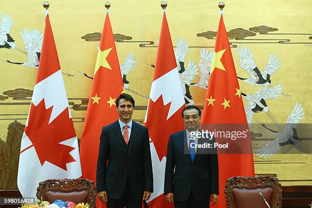 Chinese Premier Li Keqiang and Canadian Premier Justin Trudeau attend the ceremony of sign agreement documents after a meeting at the Great Hall of...