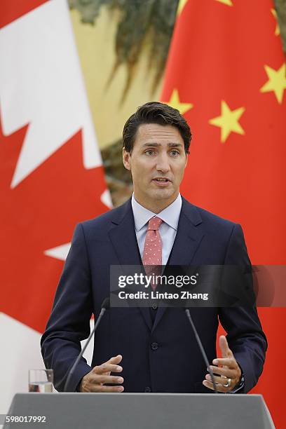 Canadian Prime Minister Justin Trudeau addresses a press conference with Chinese Premier Li Keqiang at the Great Hall of the People on August 31,...