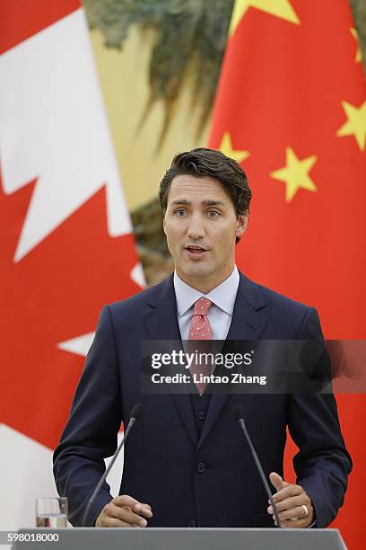 Canadian Prime Minister Justin Trudeau addresses a press conference with Chinese Premier Li Keqiang at the Great Hall of the People on August 31,...