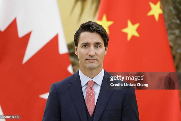 Canadian Prime Minister Justin Trudeau addresses a press conference with Chinese Premier Li Keqiang at the Great Hall of the People on August 31,...