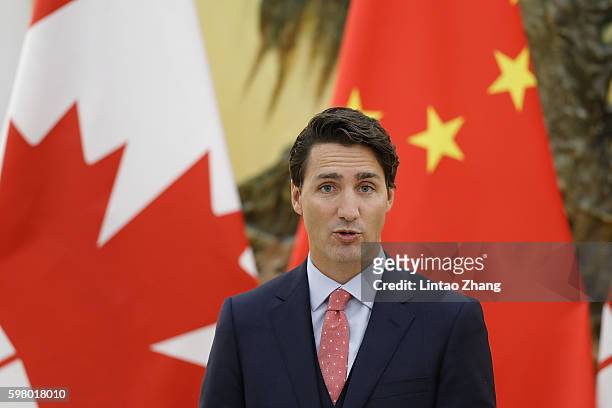 Canadian Prime Minister Justin Trudeau addresses a press conference with Chinese Premier Li Keqiang at the Great Hall of the People on August 31,...
