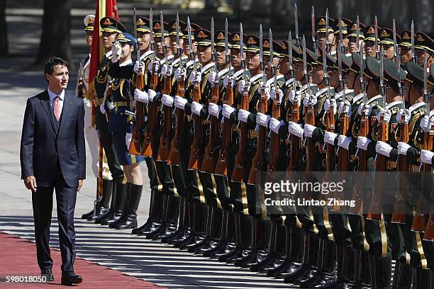Canadian Prime Minister Justin Trudeau views a guard of honour during a welcoming ceremony outside the Great Hall of the People on August 31, 2016 in...
