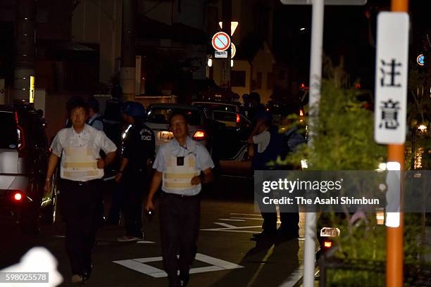 Police officers surround the area where armed suspect Yasuhide Mizobata has holed up on August 30, 2016 in Wakayama, Japan. Police have surrounded...