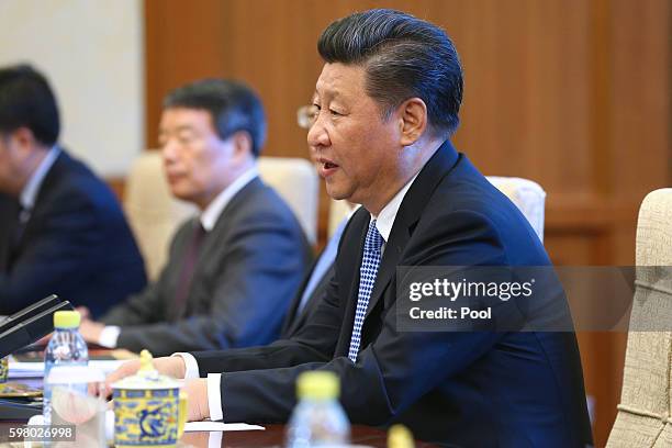 Chinese President Xi Jinping speaks with Canadian Premier Justin Trudeau during their meeting at the Diaoyutai State Guesthouse in Beijing, China, 31...