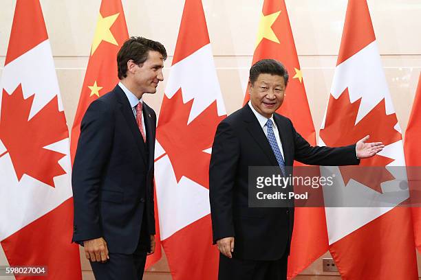 Chinese President Xi Jinping gestures to Canadian Premier Justin Trudeau ahead of their meeting at the Diaoyutai State Guesthouse in Beijing, China,...