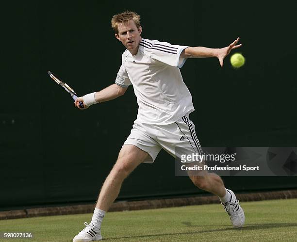 Jonathan Marray of Great Britain in action against Xavier Malisse of Belgium during the second day of the Wimbledon Lawn Tennis Championship on June...