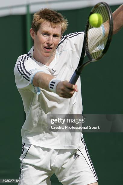 Jonathan Marray of Great Britain in action against Xavier Malisse of Belgium during the second day of the Wimbledon Lawn Tennis Championship on June...