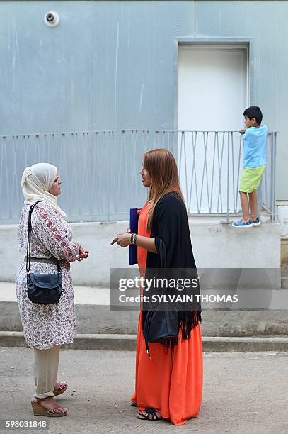 Fathua and a member of the collective of parents of student of the Petit Bard speak to one another on August 30, 2016 in Montpellier, two days before...