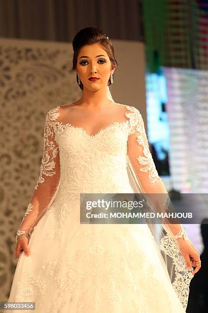 Model displays a dress created by Brazilian designer Lucas Anderi during the Omani Women's Fashion Trends event, in the Omani capital Muscat, on...