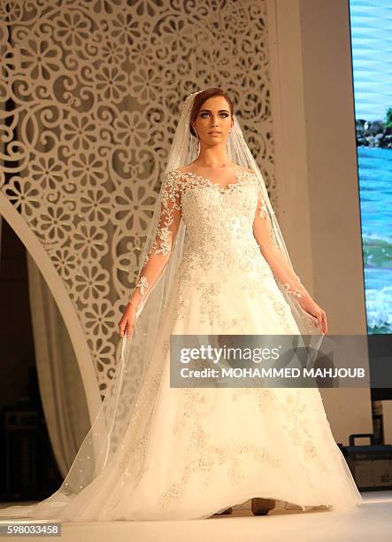 Model displays a dress created by Brazilian designer Lucas Anderi during the Omani Women's Fashion Trends event, in the Omani capital Muscat, on...