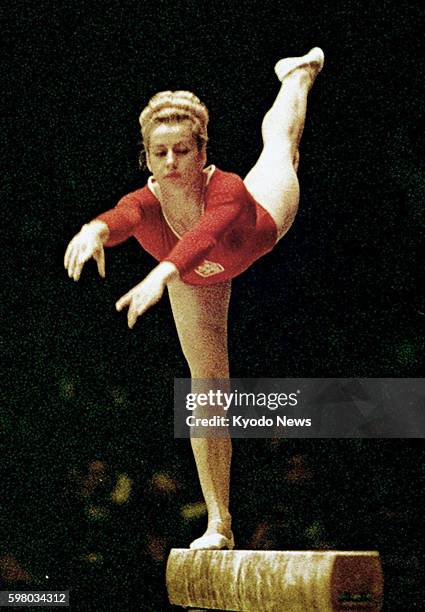 File photo taken in October 1964 shows Czech gymnast Vera Caslavska performing on the balance beam at the Tokyo Olympic Games. Caslavska, who claimed...