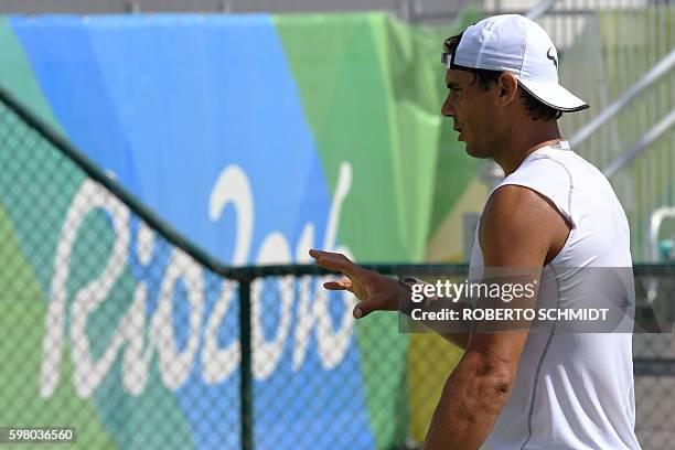 Rafael Nadal waits to be handed a tennis ball during a practice session at the Olympic Tennis Center in Rio de Janeiro on August 2 ahead of the Rio...