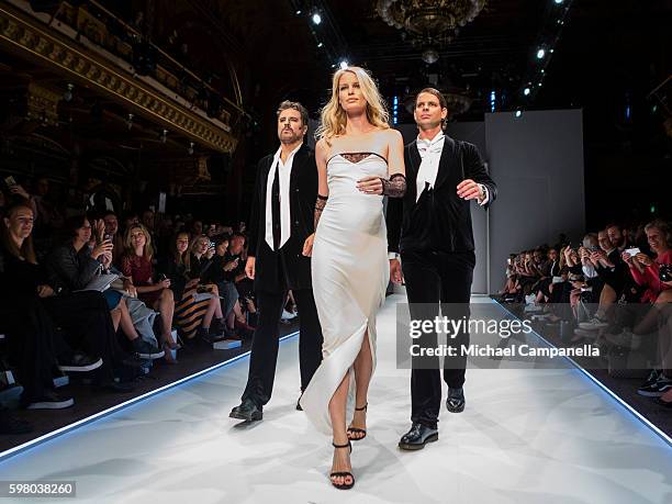Model Caroline Winberg walks the runway with Sigge Eklund and Alex Schulman during the Daisy Grace show on the third day of Stockholm Fashion Week on...