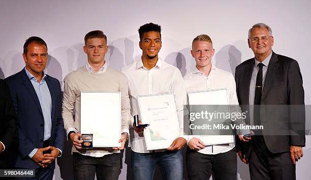 Benjamin Henrichs of Bayer 04 Leverkusen, Philipp Ochs of TSG 1899 Hoffenheim and Maximilian Mittelstaedt of Hertha BSC Berlin are awarded by DFB...