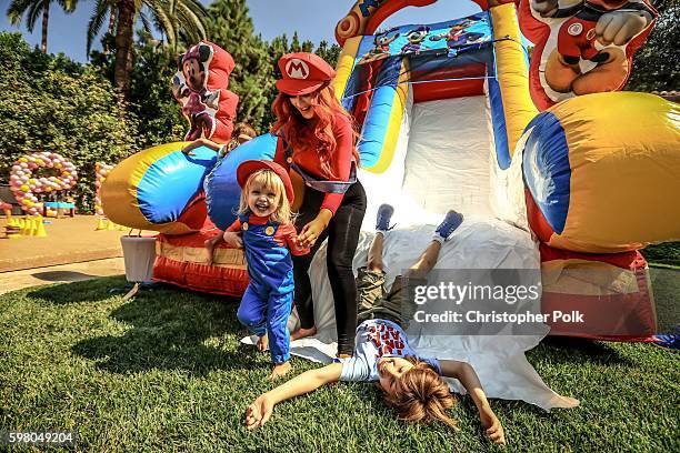 Singer Christina Aguilera , her daughter Summer Rain Rutler and son Max Liron Bratman smile and laugh as they slide down the play slide during the...