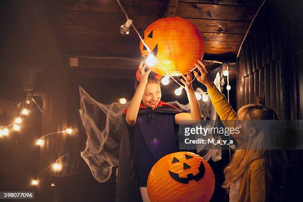 mom and daughter decorate for halloween - decoration stock pictures, royalty-free photos & images