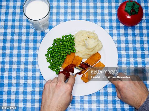 men eating fish fingers, potatoes mash and peas - fish stick stock pictures, royalty-free photos & images