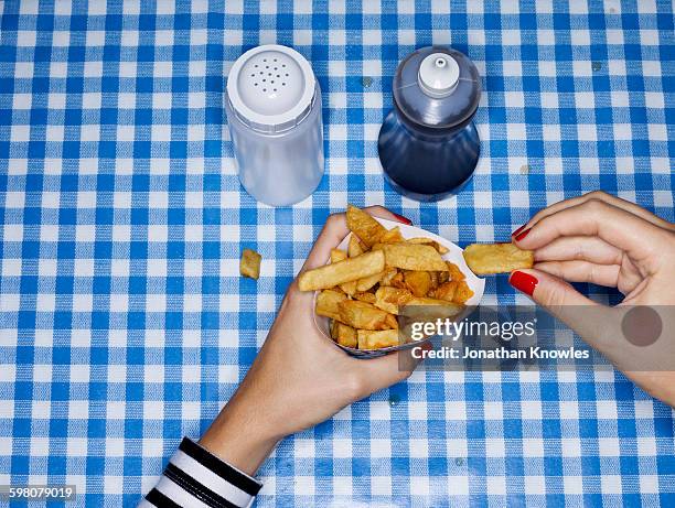 female eating chips with salt and vinegar - eating fast food stock-fotos und bilder