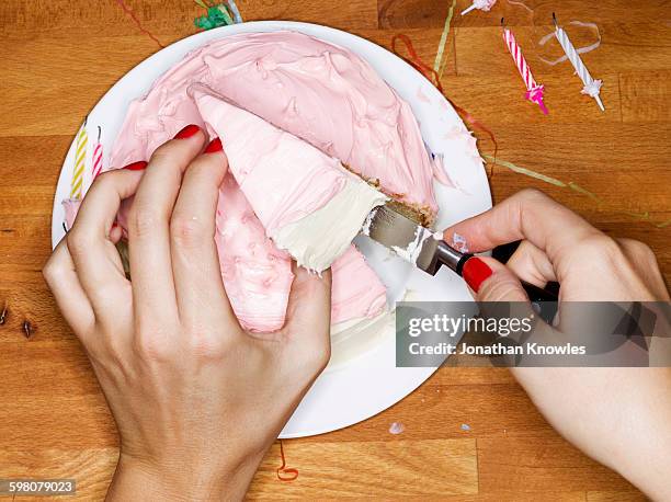 female taking a slice of cake - birthday cake from above stock pictures, royalty-free photos & images