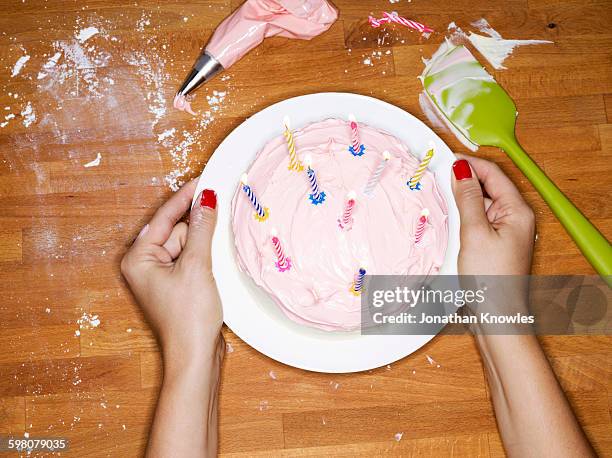 female presenting cake with lit candles - birthday cake lots of candles 個照片及圖片檔