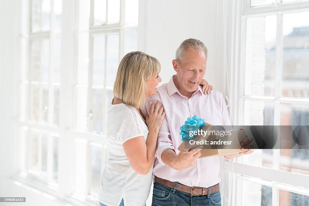 Woman giving present to her husband