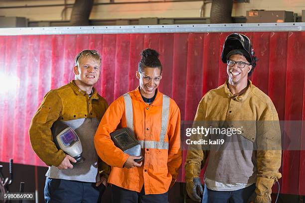 three multi-ethnic workers with welding equipment - metaalbewerking stockfoto's en -beelden