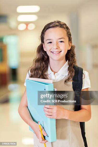 pretty private school girl in the hallway - charter school stock pictures, royalty-free photos & images