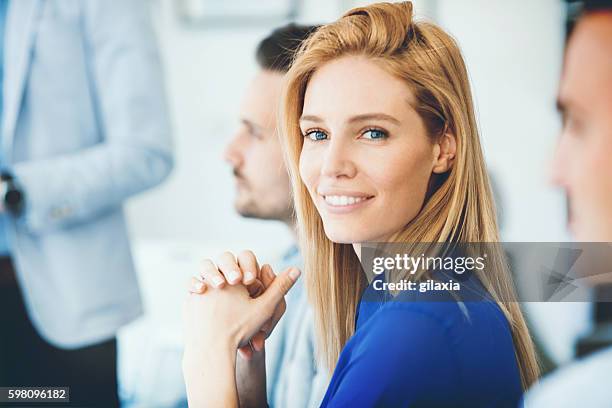 buswinesswoman in a meeting. - 40 year old woman blonde blue eyes stock pictures, royalty-free photos & images