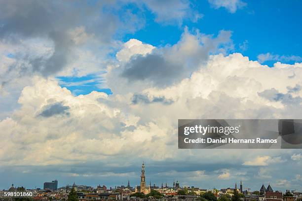 distant view of amsterdam skyline with a church westerkerk in background - skyline amsterdam stock pictures, royalty-free photos & images