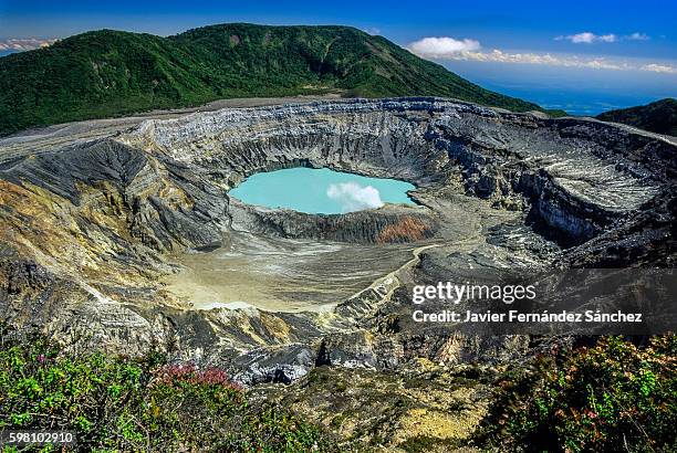 poas volcano crater with its lake and fumarole, in costa rica. an active stratovolcano that is one of the most important tourist destinations in the central american country. - acid rain stock pictures, royalty-free photos & images