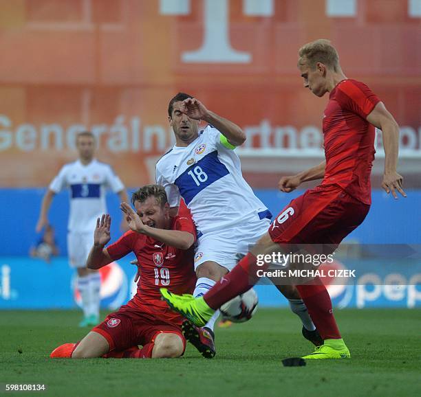 Ladislav Krejci and Lukas Pokorny, both of Czech Republic vie for the ball with Henrik Mchitarjan of Armenia during the friendly soccer match...