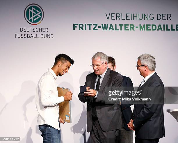 Benjamin Henrichs of Bayer 04 Leverkusen is awarded by DFB vice president Dr. Hans-Dieter Drewitz with the Fritz-Walter-Medal in gold for his...