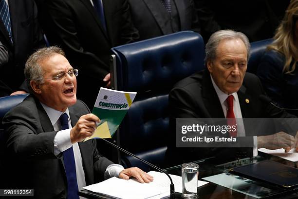 President of the Senate Renan Calheiros holds the federal constitution of Brazil at impeachment proceedings of President Dilma Rousseff August 31,...