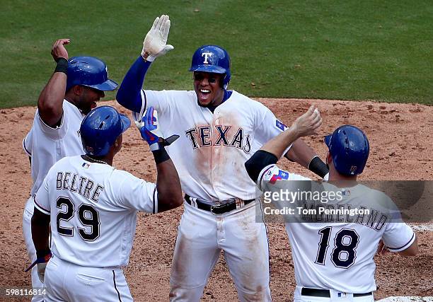 Carlos Gomez of the Texas Rangers celebrates with Elvis Andrus of the Texas Rangers, Adrian Beltre of the Texas Rangers and Mitch Moreland of the...
